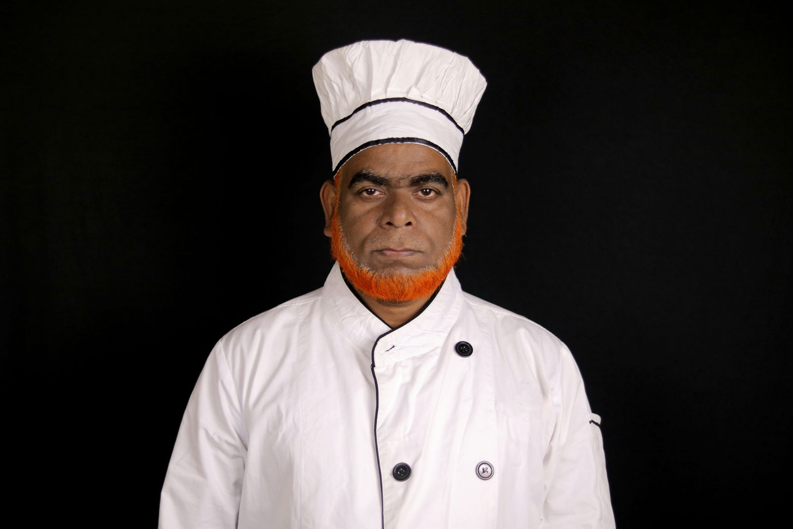 Chef wearing a clean white chef coat and hat