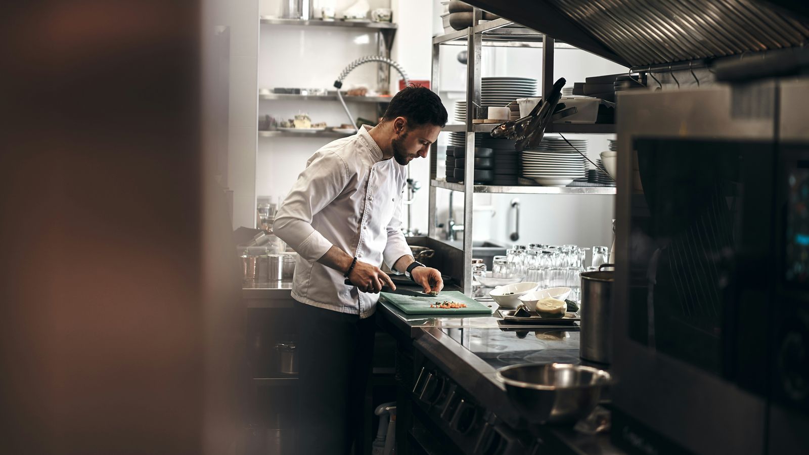 Chef in a clean white coat working in a restaurant kitchen